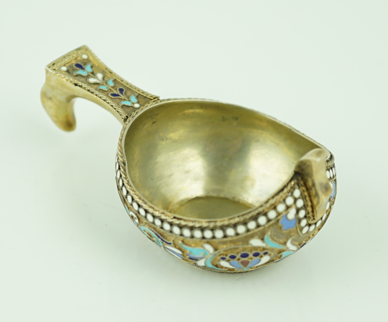 A late 19th/early 20th century Russian 84 zolotnik silver gilt and polychrome enamelled kovsh